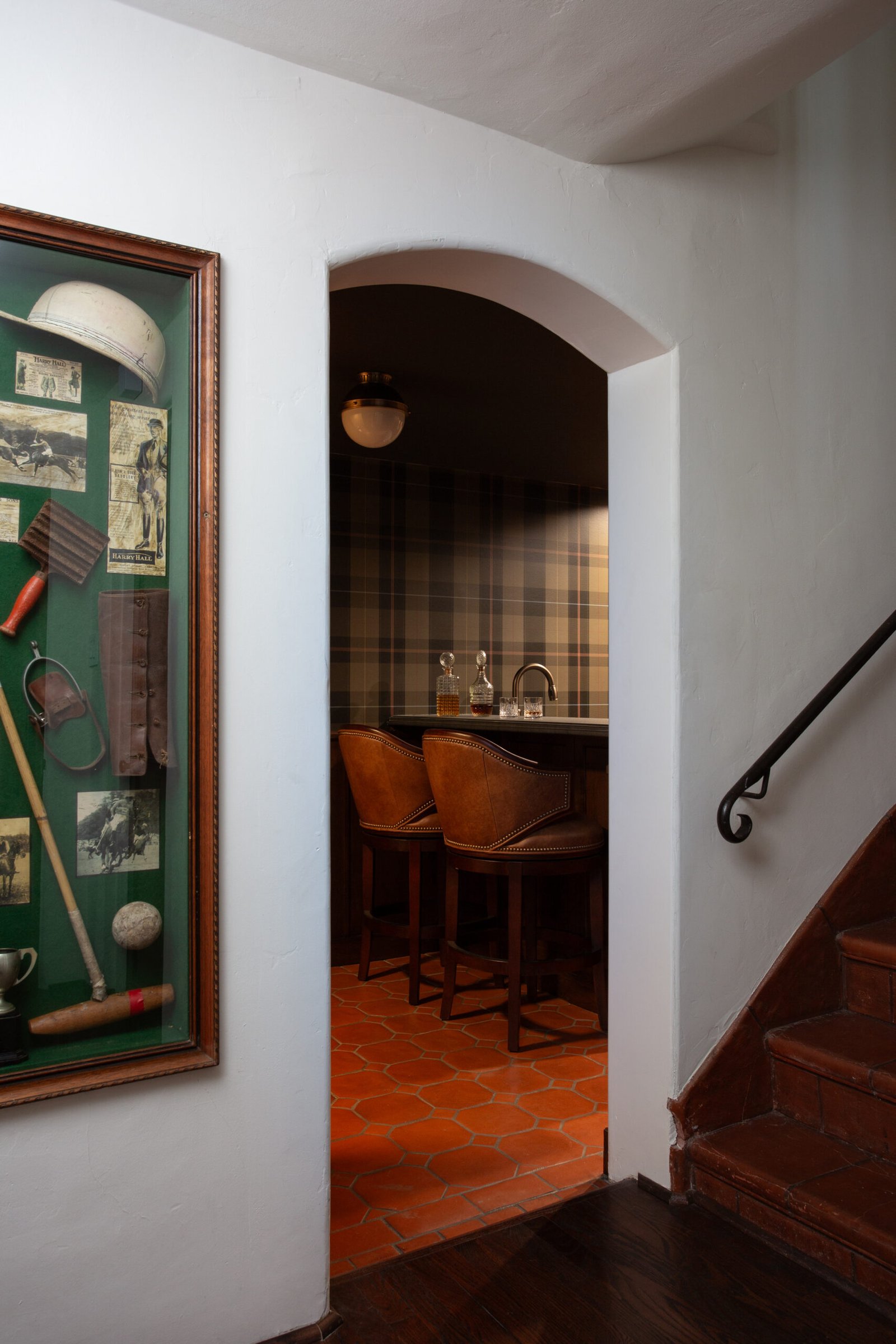 Custom home bar with a Scottish theme inside a Spanish Revival, designed by Coco Maison.